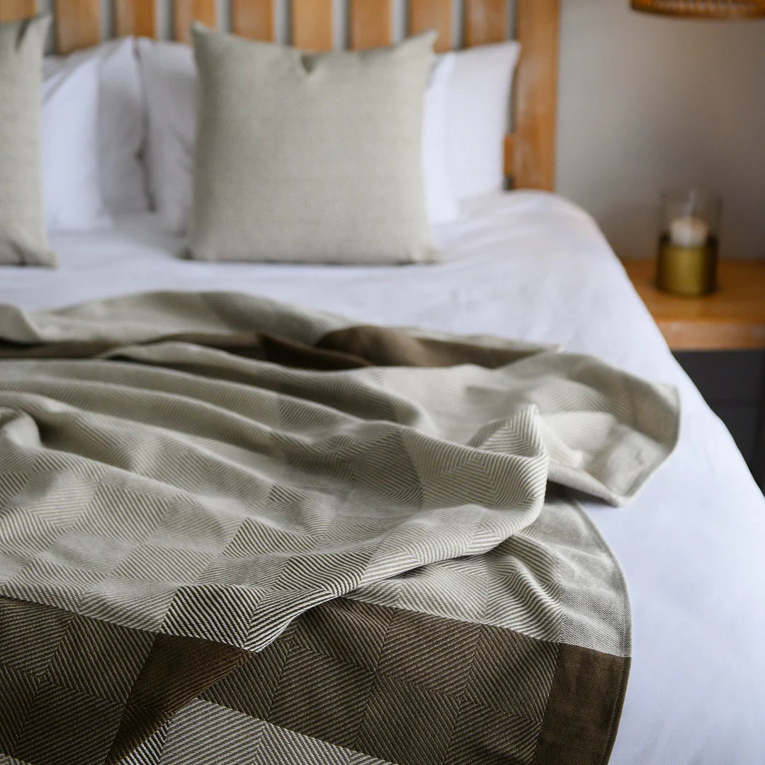  
A Protea Throw featuring intricate patterns and a soft, 
luxurious texture, on a lodge bed. Its hand-knotted fringes 
add a touch of elegance, making it a perfect choice for lodges 
and guesthouses aiming to impress their guests. #LodgeLuxury #PremiumBlankets #GuestExperience #HospitalityExcellence #SouthAfricanCraftsmanship