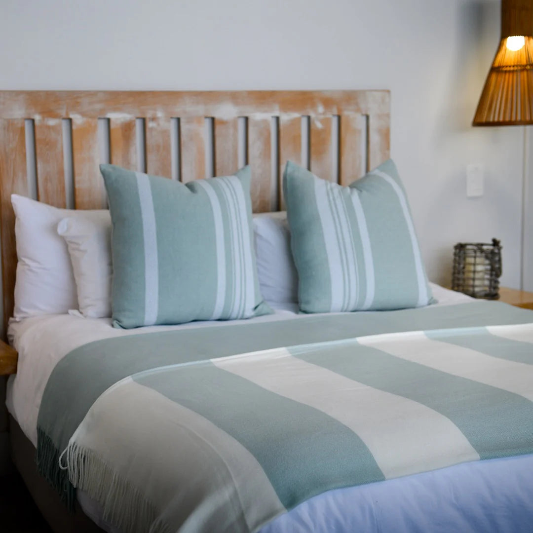 A Melody Mariner throw, elegantly spread across a neatly made bed, showcasing its soft texture and nautical-inspired design. Ideal for creating a cozy, sophisticated ambiance in any lodge or guesthouse. #LodgeLuxury #HotelComfort #PremiumBlankets #GuestSatisfaction #HospitalityExcellence