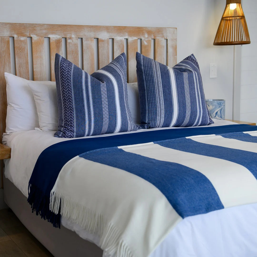 A Melody Mariner throw, elegantly spread across a neatly made bed, showcasing its soft texture and nautical-inspired design. Ideal for creating a cozy, sophisticated ambiance in any lodge or guesthouse. #LodgeLuxury #HotelComfort #PremiumBlankets #GuestSatisfaction #HospitalityExcellence