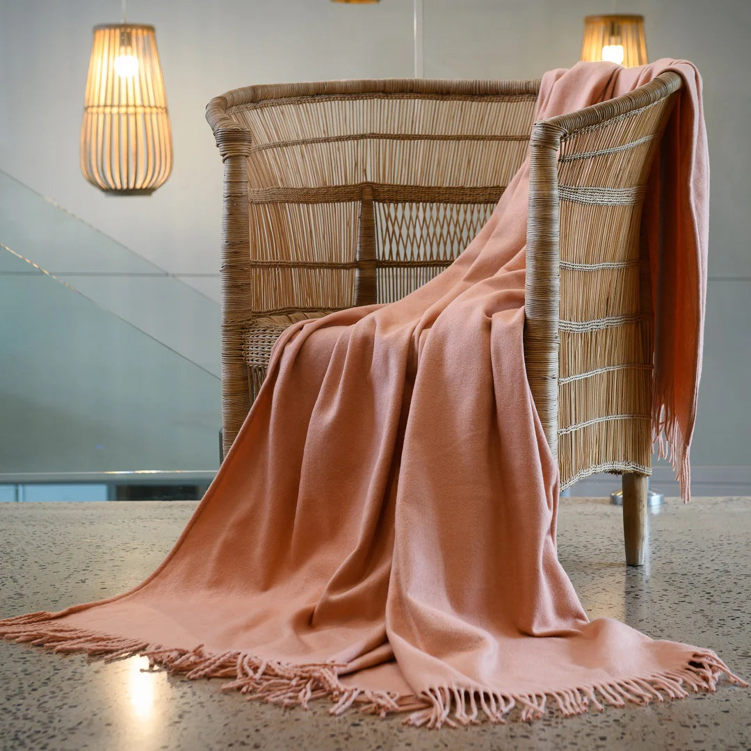 A Melody Plain throw i draped over a cozy armchair, showcasing its ultra-soft fabric and elegant simplicity. Perfect for year-round comfort. #LodgeLuxury #PremiumBlankets #HospitalityExcellence #ArandaQuality