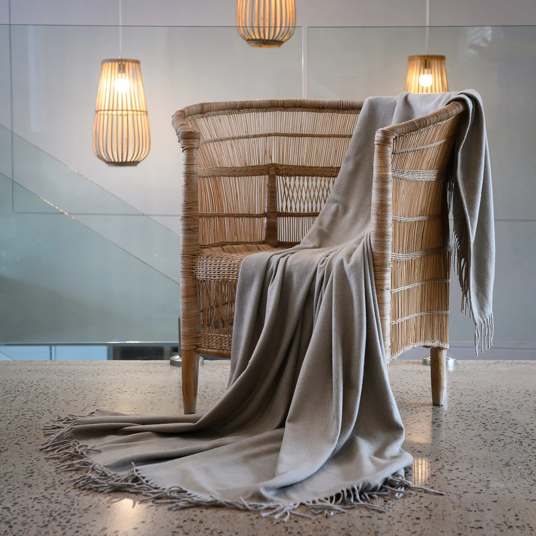 A Melody Plain throw draped over a cozy armchair, showcasing its ultra-soft fabric and elegant simplicity. Perfect for year-round comfort. #LodgeLuxury #PremiumBlankets #HospitalityExcellence #ArandaQuality