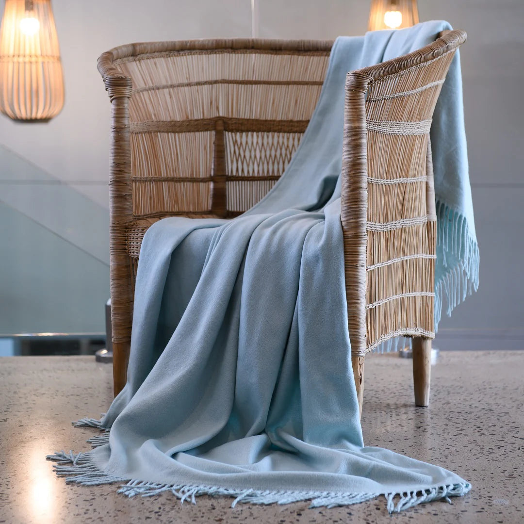 A Melody Plain throw draped over a cozy armchair, showcasing its ultra-soft fabric and elegant simplicity. Perfect for year-round comfort. #LodgeLuxury #PremiumBlankets #HospitalityExcellence #ArandaQuality