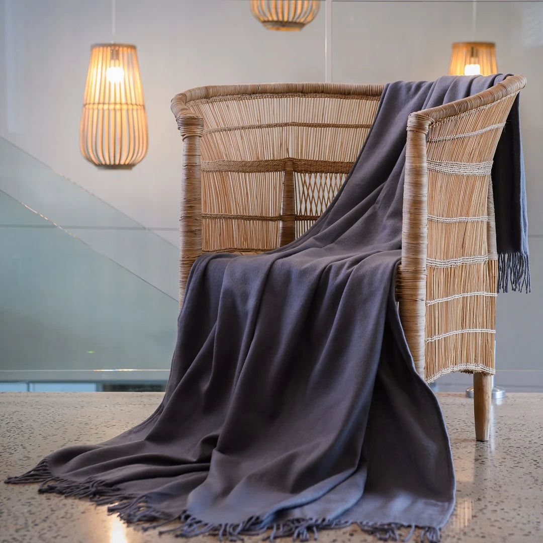 A Melody Plain throw draped over a cozy armchair, showcasing its ultra-soft fabric and elegant simplicity. Perfect for year-round comfort. #LodgeLuxury #PremiumBlankets #HospitalityExcellence #ArandaQuality