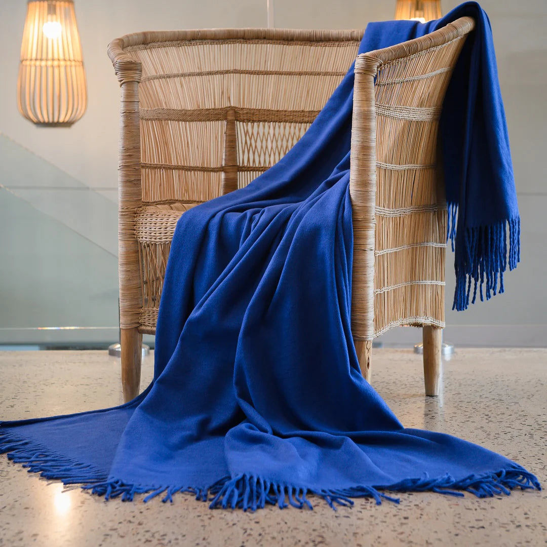 A Melody Plain throw draped over a cozy armchair, showcasing its ultra-soft fabric and elegant simplicity. Perfect for year-round comfort. #LodgeLuxury #PremiumBlankets #HospitalityExcellence #ArandaQuality