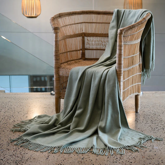 A Melody Plain throw draped over a cozy armchair, showcasing its ultra-soft fabric and elegant simplicity. Perfect for year-round comfort. #LodgeLuxury #PremiumBlankets #HospitalityExcellence #ArandaQuality